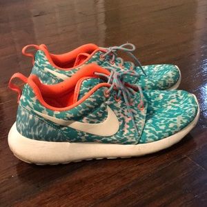 Teal, white, & orange Nike tennis shoes